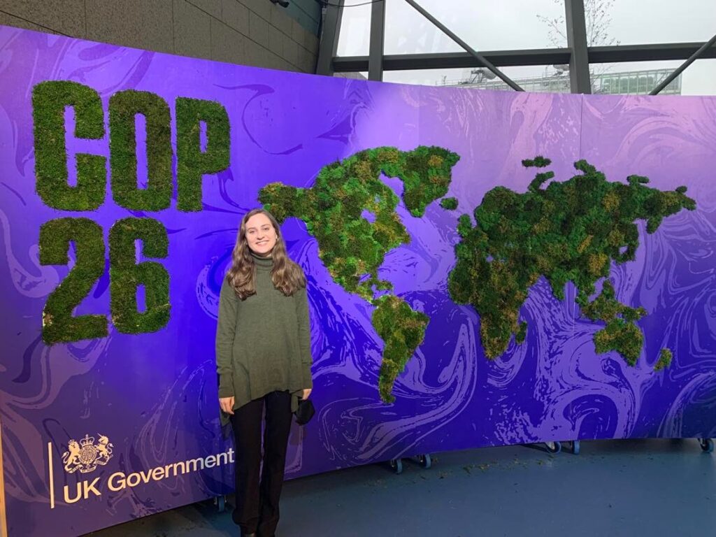 Jessica Chaplain, PhD student in Communications at the U, poses at the entrance of COP26 in Glasgow, Scotland at the beginning of November 2021.