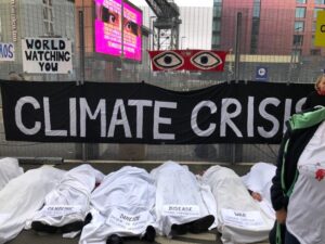 This was a protest by Extinction Rebellion right outside the entrance of COP26 to highlight the death and destruction enabled by climate inaction.